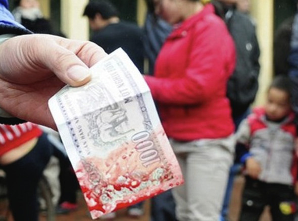 People dip their money in the pig's blood to give them good luck and wealth.